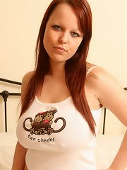 Cheeky redhead strips to show off her jugs